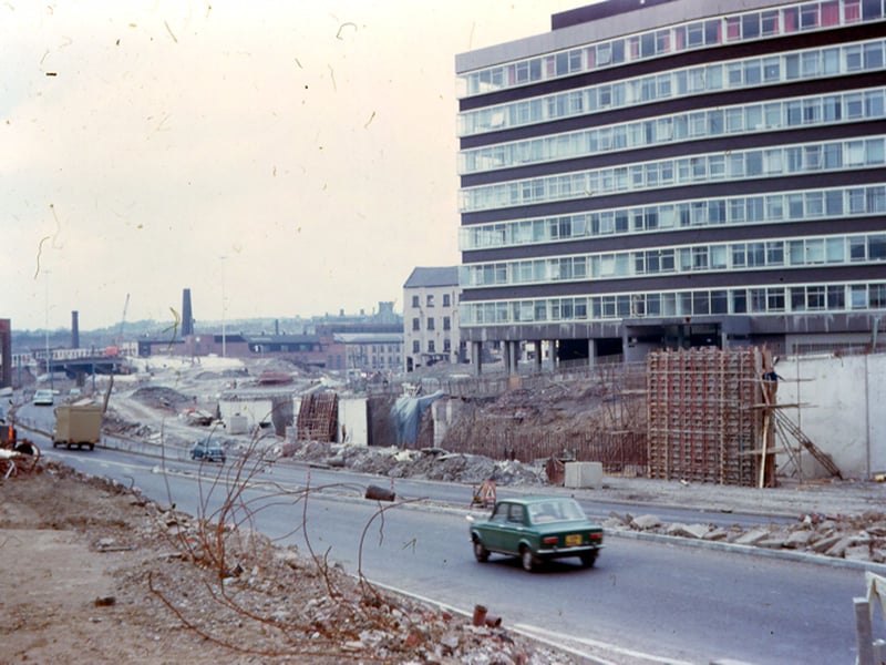 A view looking west from Westgate showing the construction of Stage 3 of the Inner Ring Road under a light covering of snow. To the right, Telephone House in Westgate is visible and at the far left is Dunlop Rubber Co. Ltd., motor tyre manufacturers also in Westgate.