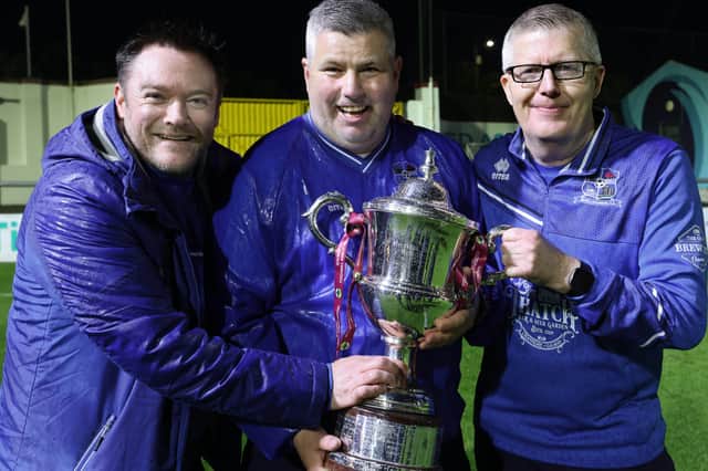 Maree-Oranmore coaches Conor Mullins, Brendan O'Connor and Noel Greaney celebrate with the Michael Byrne Cup.