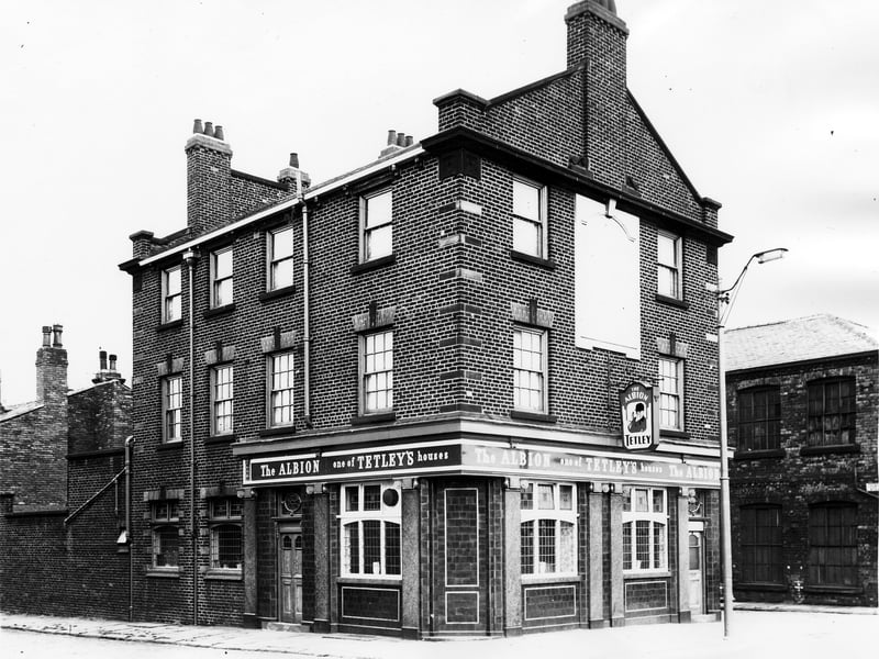 The Albion pub on Armley Road pictured in October 1963. This public house with its column's and tiled facade is a Tetley house, and the Tetley huntsman logo is visible on the wall. On the left of the photo is Brunel Street. On the far right is Arkwright Street.