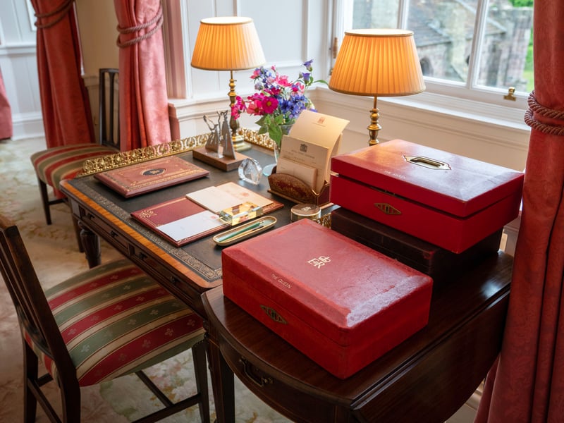 The desk in the Sitting Room where the late Queen Elizabeth II would work, reviewing the
papers and documents presented in the Government red dispatch boxes, at the Palace of Holyroodhouse in Edinburgh, the official residence of the monarch in Scotland. 