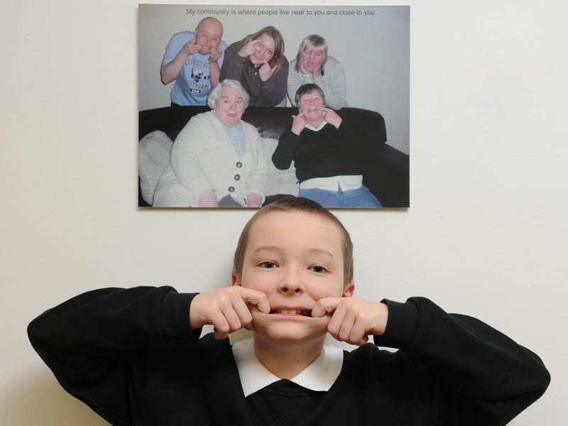 As part of an exhibition of photos by pupils, parents and carers at Sighthill Primary School in January, 2011, 10 year old Lewis Simmonds strikes a similar pose to the one adopted by his family members in the picture he took for the exhibition.