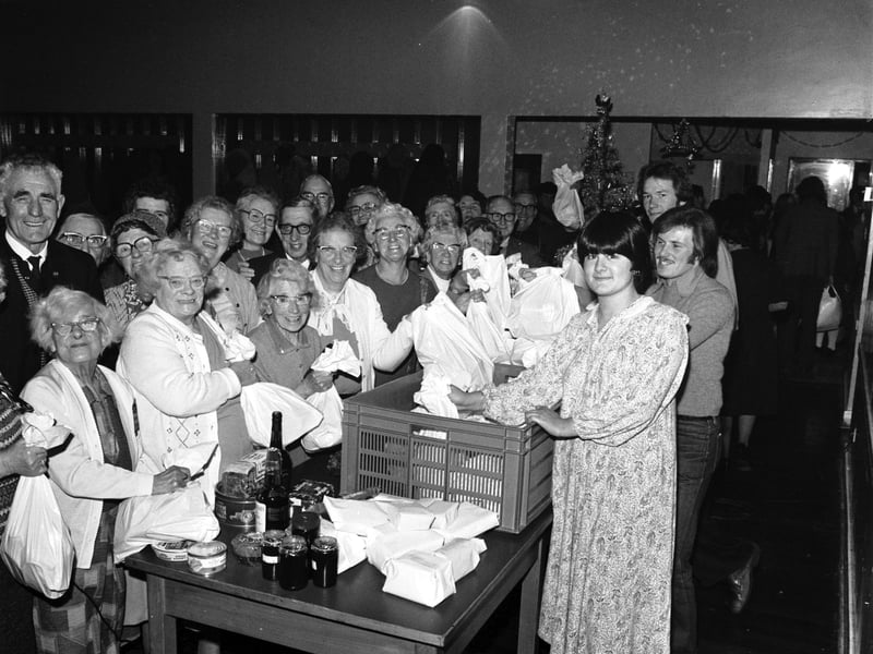 Students from Napier College in Edinburgh with Christmas food parcels for old age pensioners at Sighthill community centre in December 1978.