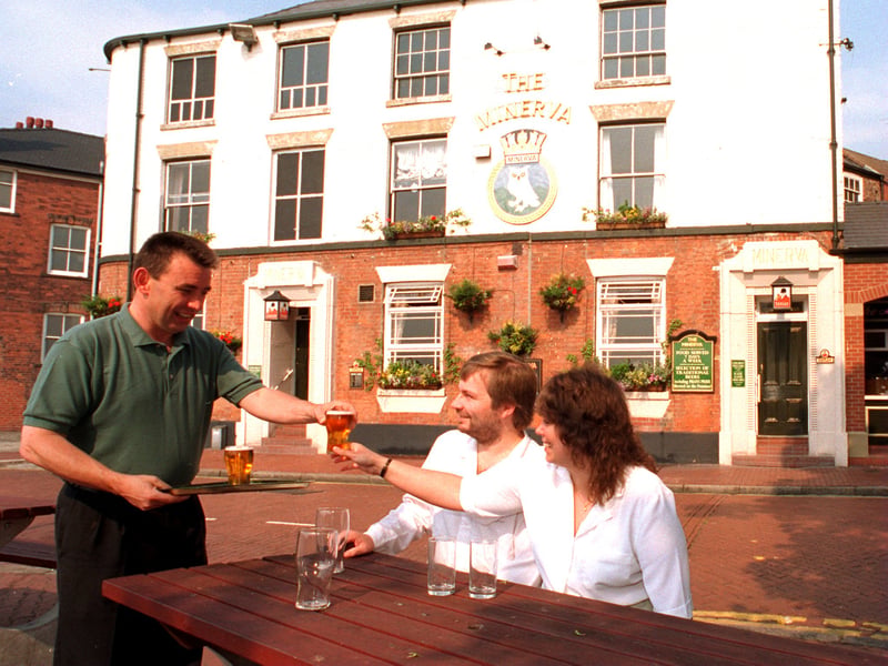 Eamon Scott, landlord of the Minerva pub, Hull, serves Maureen and Ken Lussey, authors of an internet guide to pubs in the city, in July 1996