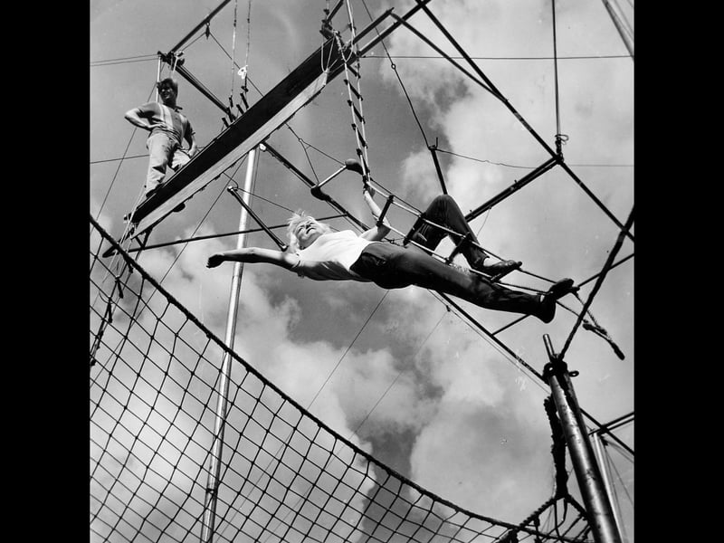 Triss Farrow soaks up the sunshine high above the crowds at Shrewsbury Flower Show in August 1964. Part of the Hungarian trapeze troupe the Leotaris, the daring performers thrilled thousands of visitors with their breathtaking aerial displays.