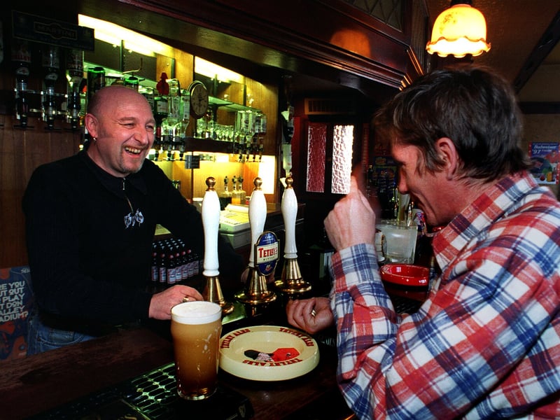 Michael Deeley, landlord of The Washington pub, on Fitzwilliam Street, Sheffield, shares a joke with a customer in 1997