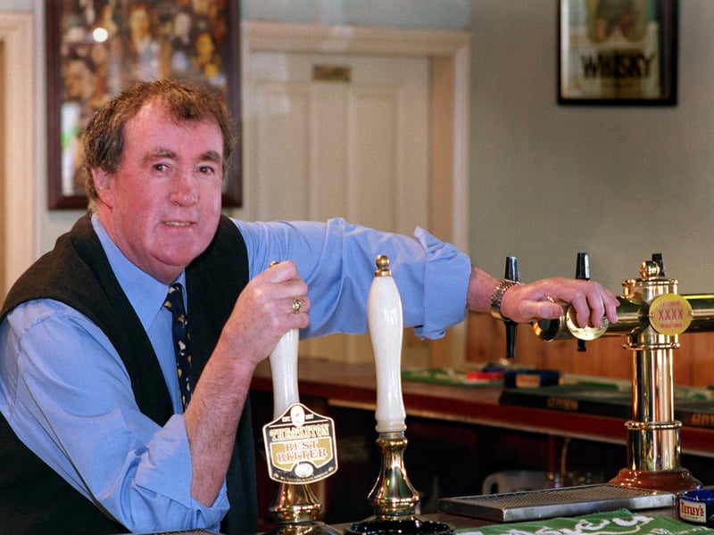 Ben Maguire, landlord of Maguire's in Bradford, enjoys a pint and a pipe in his pub bar in 1999
