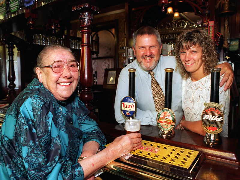 Majorie Farnsworth enjoys a drink in the Cardigan Arms on Kirkstall Road, Leeds, with the pub's landlord and landlady, Barrie and Janet Edmands, who rescued her from her blazing flat nearby and were awarded for their bravery, in 1997