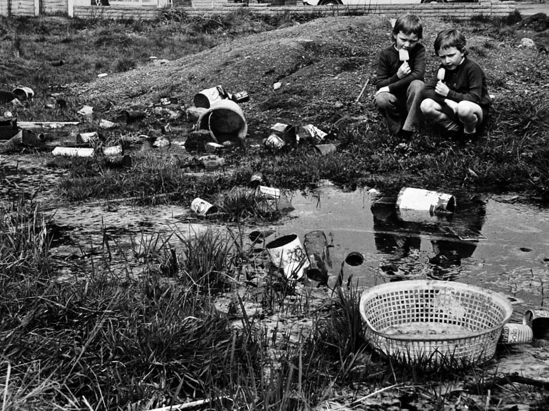 Brothers Adrian and Sean Spencer play beside a stagnant pool filled with rubbish on wasteland behind their home on the Coppice Farm estate in New Invention in May 1975. Residents described the council-owned land as an eyesore and health risk, claiming rubbish and waste were regularly dumped there. The site was also earmarked for road widening. Do you remember this area of New Invention, or the problems caused by the wasteland?