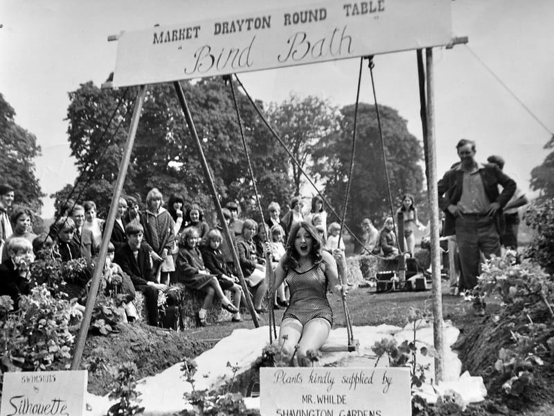 Fun at the Grove School summer fair in Market Drayton, believed to have taken place in July 1968. This charming scene features the Market Drayton Round Table Bird Bath. The girl on the swing is thought possibly to be Nicola Cox.