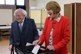 Michael D Higgins and his wife Sabina casting their votes at Westside Community Centre polling station on Friday morning.