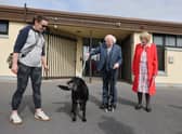 Michelle Bermingham and her dog Chalky greet President Michael D Higgins and his wife Sabine Higgins at the polling centre in Westside. 