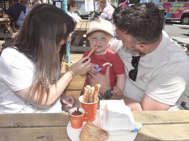 Hollie and Lee Dimmick from Portsmouth, enjoy Churros with their one-year-old son Jaxon.
