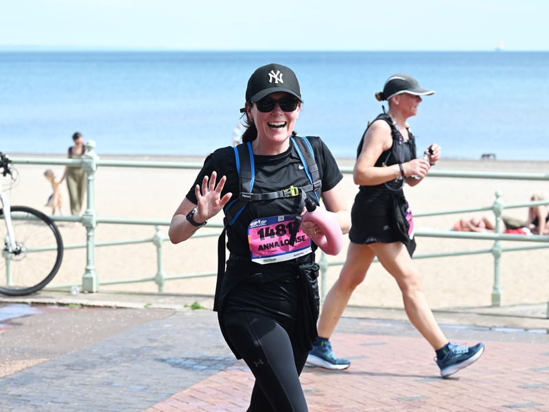 This runner was still full of cheer and up for a wave at Portobello Promenade.
