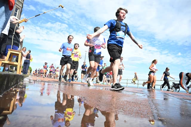 Runners are sprayed with water as they head along Portobello Promenade.