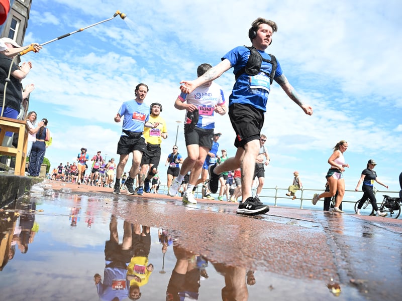 Runners are sprayed with water as they head along Portobello Promenade.
