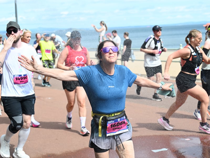 Runners are sprayed with water as they pass along the promenade in Portobello.