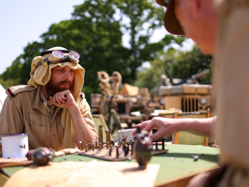 Ben Pinches, left, and Tony Edmonds playing chess. They are part of The Lone Rat Living History Desert Group. 