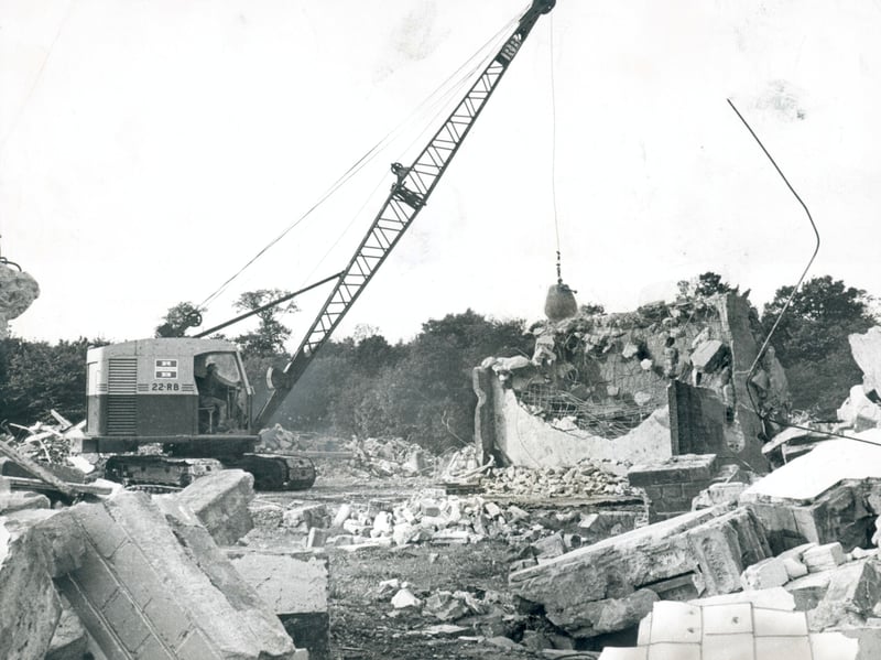 A heavy crane fitted with a wrecking ball smashes through concrete structures at the former Baggeridge Colliery in Gospel End, Sedgley, in October 1970. First developed in 1896 when the Earl of Dudley began boring for deep-set coal at the local beauty spot, the historic pit produced millions of tons of coal before industrial mining finally drew to a close in 1968. The dramatic clearance scene marked the end of an influential mining era, laying the groundwork for the site to eventually be reclaimed and reborn as a popular country park. Do you remember seeing the old colliery buildings being pulled down around Gospel End back in 1970? Did anyone in your family work down the pit at Baggeridge Colliery during its operational years?