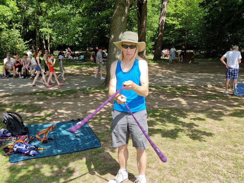 A performer swings sticks in the sun in Endcliffe Park. Photo: Iconic Media