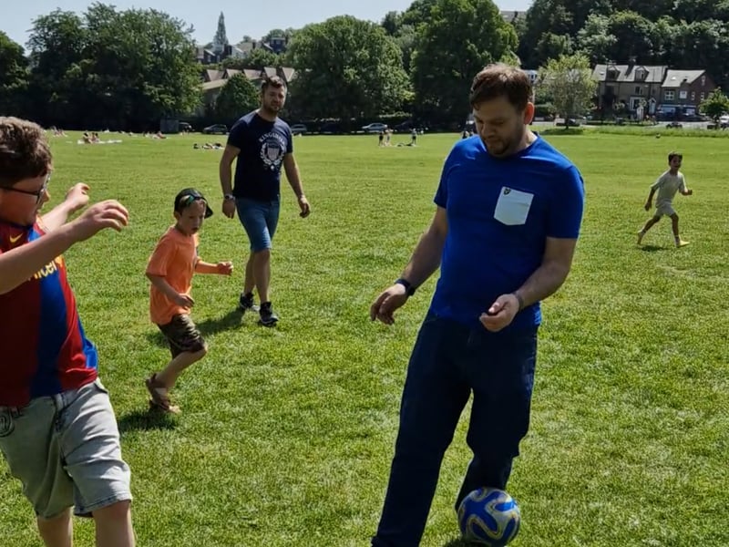 A family enjoys a game of football in Endcliffe Park, Photo: Iconic Media
