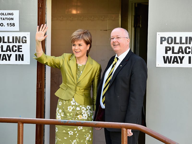 First Minister of Scotland and leader of the SNP Nicola Sturgeon, votes with her husband Peter Murrell in the UK General Election on May 7, 2015, in Glasgow.