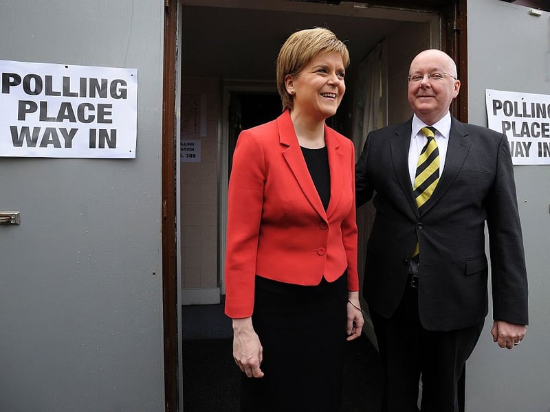Scotland's First Minister and Leader of the Scottish National Party Nicola Sturgeon and her husband Peter Murrell pose for photographers as they leave a Polling Station at Broomhouse Community Hall in East Glasgow, on May 5, 2016, after casting their votes in the Holyrood Election.