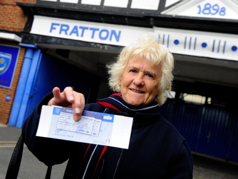 Season-ticket holder Angela Brookes shows off their 2013-14 season ticket after waiting in line.