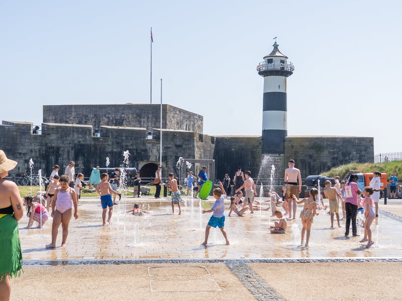 People enjoying the bank holiday sun in Southsea at the water fountains in front of Southsea Castle . Pictured by Alec Chapman