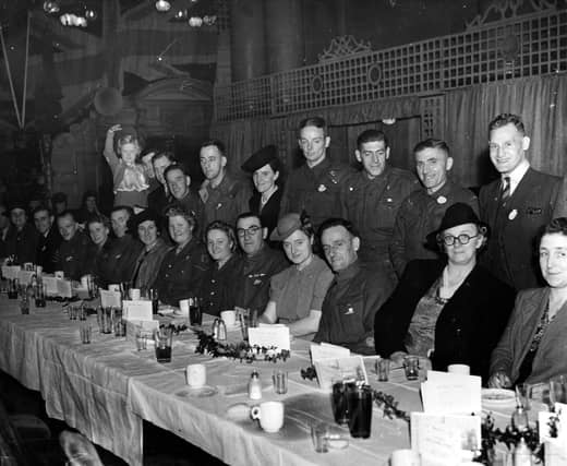 Guests at a lunch in Leeds Town Hall. This event was organised by the Yorkshire Evening News POW club for men who had returned in 1943. Some of them are seen here with their families.