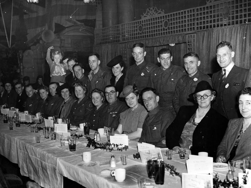 Guests at a lunch in Leeds Town Hall. This event was organised by the Yorkshire Evening News POW club for men who had returned in 1943. Some of them are seen here with their families.