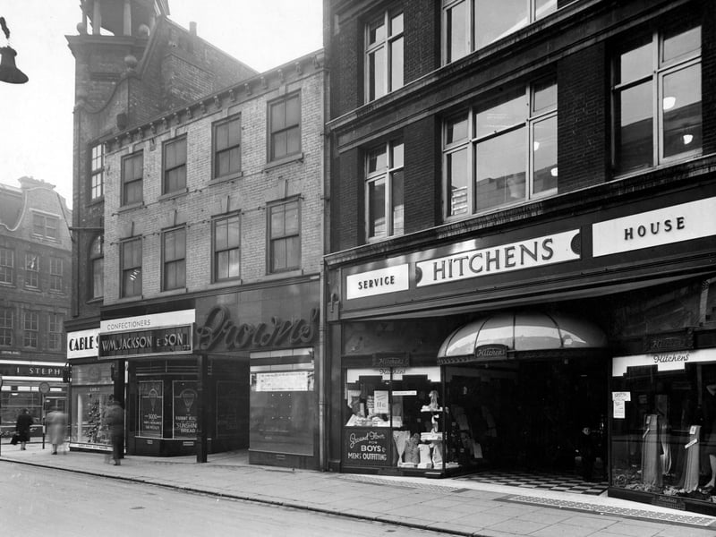 Shops on Kirkgate at the end of Central Road. Stephenson's butchers, Cable shoes, Jackson and Son Ltd. confectioners, "Browns" and Hitchen and Son Ltd. fancy drapers shown. Pictured in November 1943.