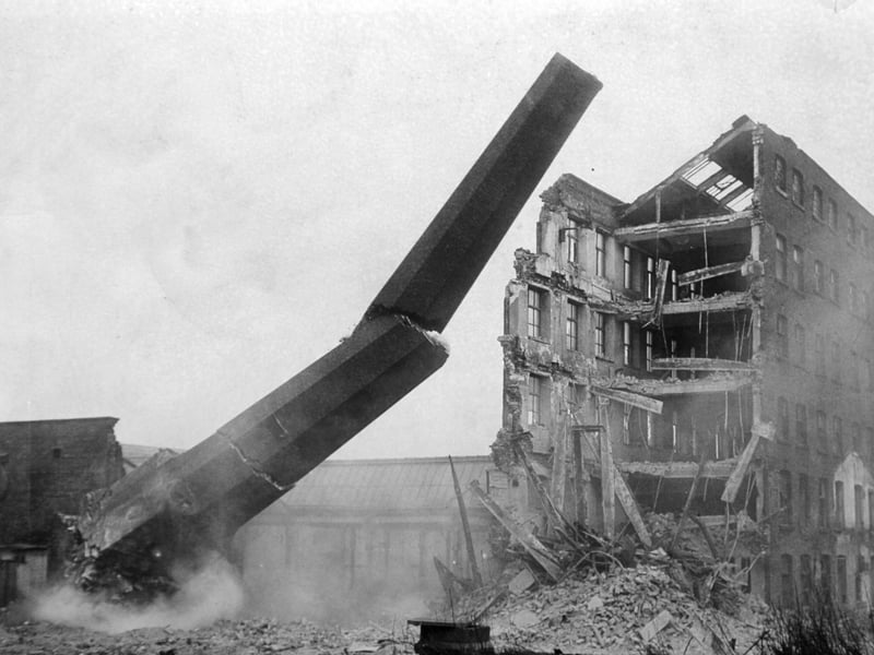 One of the chimney stacks at Bean Ing Mills, on Wellington Street, Leeds, being demolished in 1965