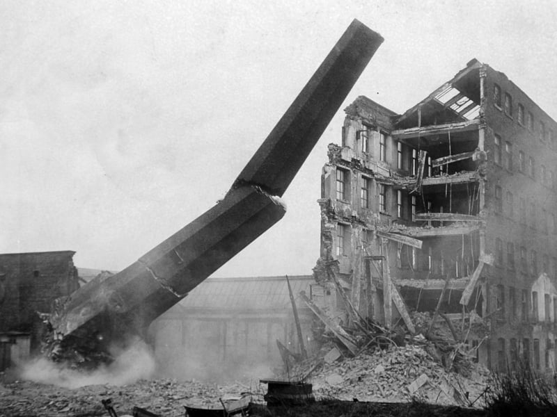 One of the chimney stacks at Bean Ing Mills, on Wellington Street, Leeds, being demolished in 1965