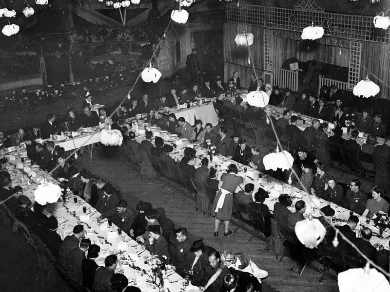 An overview of lunch party in Leeds Town Hall in November 1943. This was sponsored by the Yorkshire Evening News who organised a POW club. In 1943 a number of prisoners were repatriated, the Yorkshire men came home on a Swedish liner, the 'Drottningholm'. They and their families are seen here, the waitresses are serving soup!