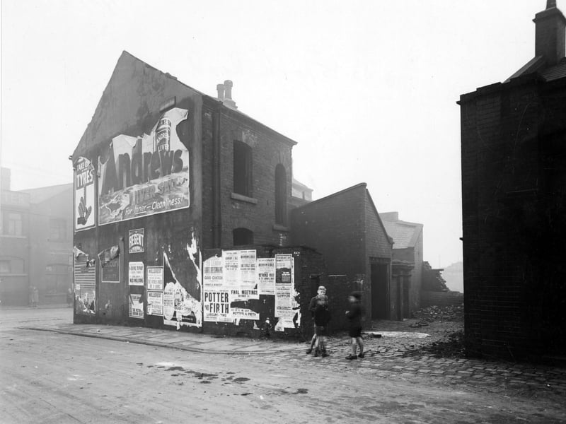 York Road in November 1945. Derelict premises of Numbers 83 and 85 on the North side of the road as seen from Blossom Street. Premises were a police station and Christopher Kelly a physician was an occupant here. Three boys are standing in the street.