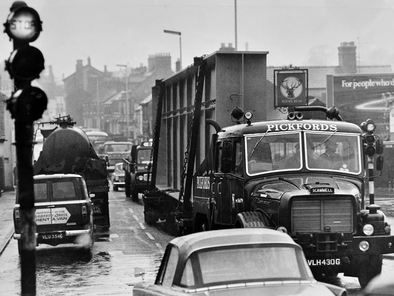 A massive Pickfords Scammell lorry crawls past the famous Buck’s Head pub in Wellington on 10 May 1969, hauling an enormous 49 ton steel girder. The 89 foot long cargo was one of six manufactured by Adamson Alliance in Horsehay for London Transport Board infrastructure works along Cromwell Road. Under police escort, the impressive convoy embarked on a deliberate 140 mile journey to the capital, drawing looks from fellow motorists navigating the busy traffic along Watling Street. Do you remember seeing this massive Pickfords convoy navigating through Wellington back in May 1969?