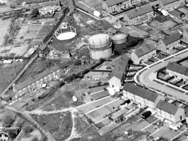 An aerial view of Dawley taken on May 17, 1961, showing a sweeping panorama of the town. Dawley town centre can be seen in the top left, while newly built 1950s housing appears in the foreground. The Manor Farm estate, including the Windsor Road area, is visible centre right. Also shown centre left are the Dawley gas works, a prominent feature of the town’s industrial landscape at the time