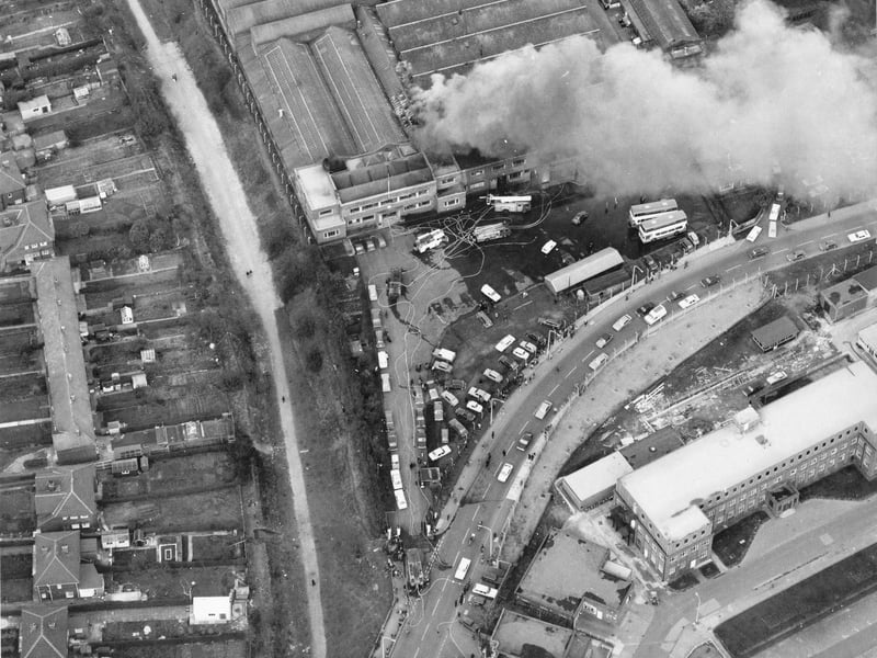 A bird's eye view of Cross Gates Carriage Works on Manston Lane, the firm of Charles H. Roe. A small fire is being attended to by several engines. Nine metro buses worth £120,000 each had to be pushed to safety. Pictured in March 1975.