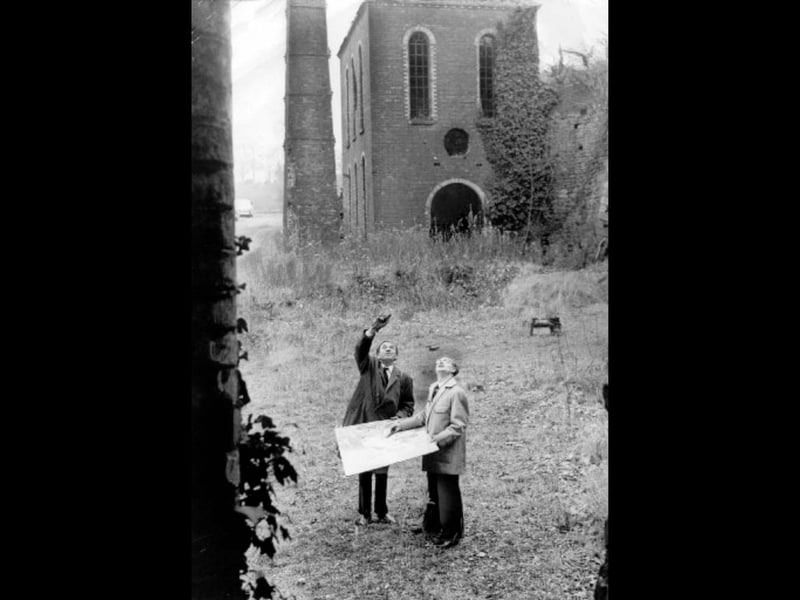 Taken on December 5, 1963, this photograph shows planning consultant Mr John H D Madin of the Dawley Development Corporation taking a long look at the rugged local countryside. The original caption notes that, above right, Mr Madin and his assistant Mr Lewis Jones are seen surveying the remains of a once prosperous ironworks, now in ruins, at Coalport