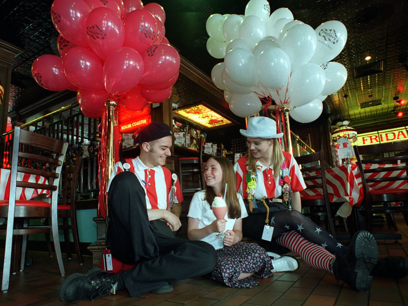 Emma Cockroft enjoys her ice cream with waiters Andy Gosling and Yvette Owens at TGI Friday.