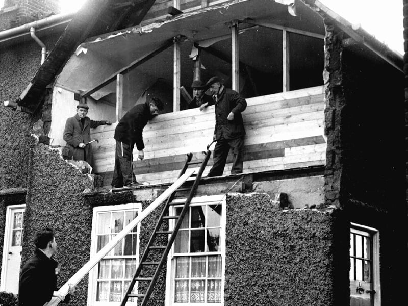 Workers boarding up the front of a house in Crookes, Sheffield, after a gale had blown out the front bedroom wall in February 1962