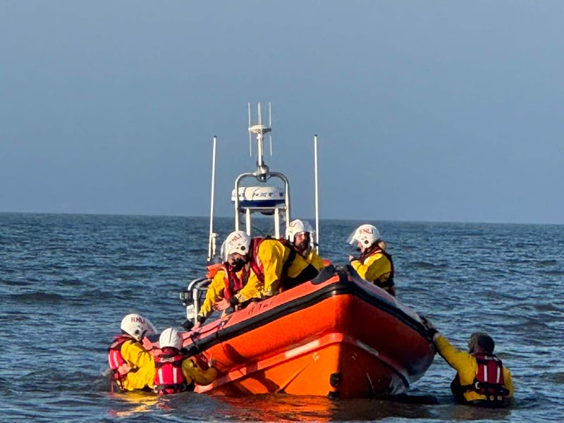 Coastguard crew in the water.