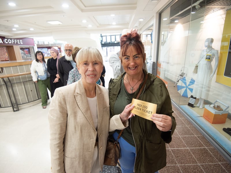 Happy Peacocks customers with theier £50 free voucher to spend in store