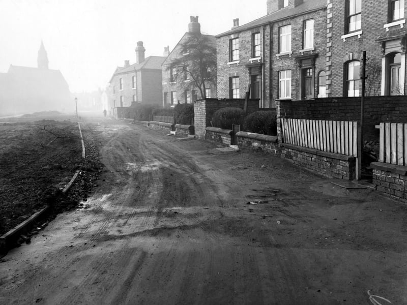 Moor Crescent in December 1955.  The church in the background of this photo is St Peters Church of England which was later demolished.