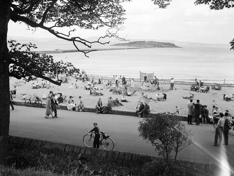 A view of the beach in Cramond showing the promenade and Cramond Island in August 1958.