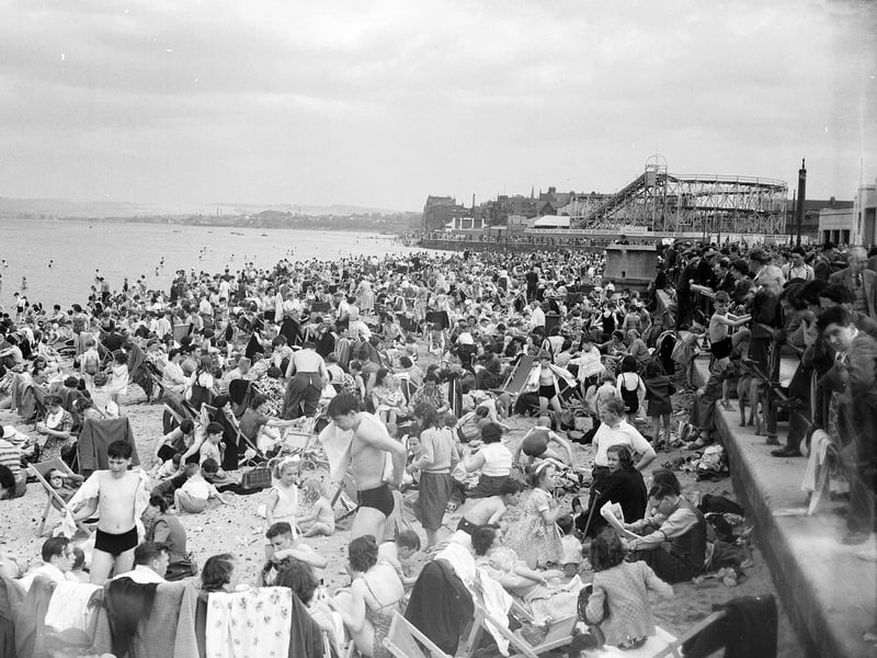 Crowds of holiday-makers on Portobello Beach in May 1952 with the rollercoaster and funfair in the background.