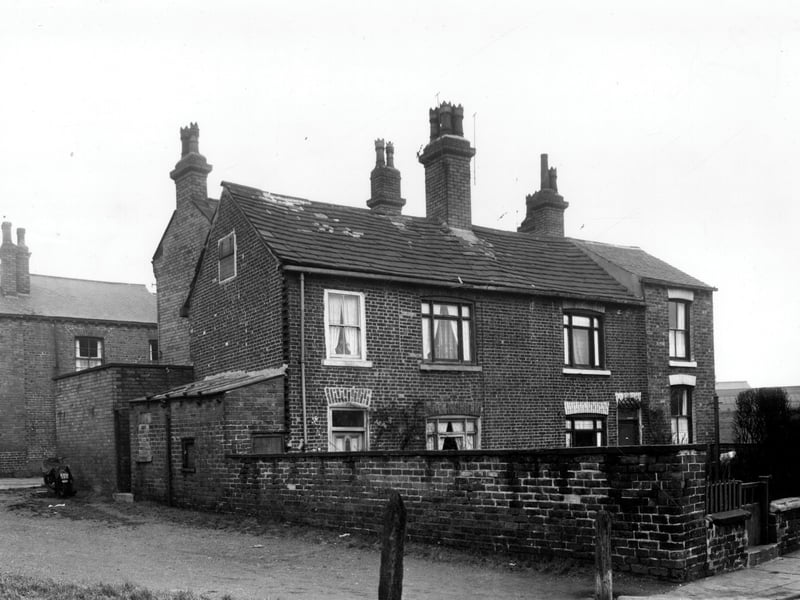 Two back-to-back terraced houses on Moor Crescent each with a private garden. On the left of number 16 is a yard, originally built to house the shared outside toilet. On the far left a passage giving access to Moor Crescent Road and has been used to park a motorcycle in. The right hand section of number 14 appears to have been built as an extension as the roof is pitched at a different level to the rest of building. Pictured in December 1958.