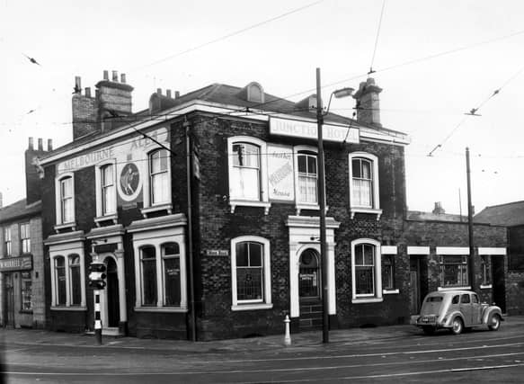 The Junction Hotel at the corner of Dewsbury Road and Moor Road pictured in December 1958. On the far left at number 135 Dewsbury Road is W. Murrell's gents hairdressing saloon.