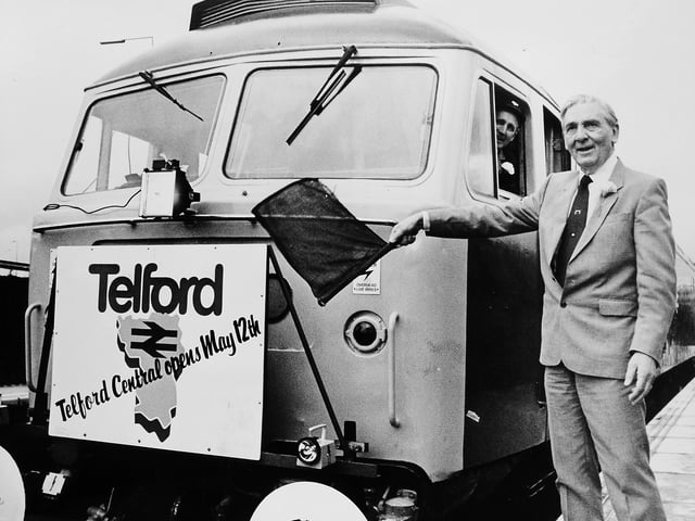 Telford Central railway station, formally opened on 12 May 1986 by Lord Murray—Len Murray, former General Secretary of the TUC and a son of Hadley—who returned to his roots to mark a major milestone in the town’s transport history. Captured during the official ceremony, he is seen flagging away the first train from the new station.