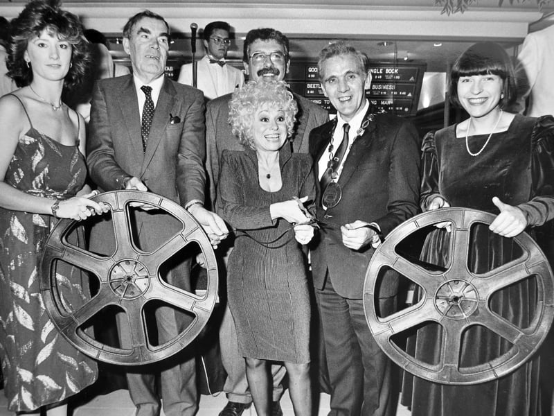 Barbara Windsor opens a new multiplex cinema in Telford town centre on November 3, 1988, marking the launch of the AMC 10-screen complex. She is pictured cutting a reel of film, with civic and cinema officials in attendance. The venue opened to the public the following day and later became the UCI cinema and then the Odeon.